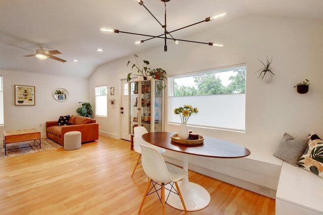 2000 E 8th St, Austin, TX 78702 - dining space with vaulted ceiling, a chandelier, light wood-style flooring, and baseboards