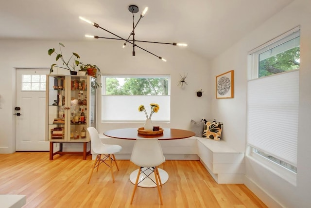 2000 E 8th St, Austin, TX 78702 - dining space with a chandelier, wood finished floors, healthy amount of natural light, and vaulted ceiling