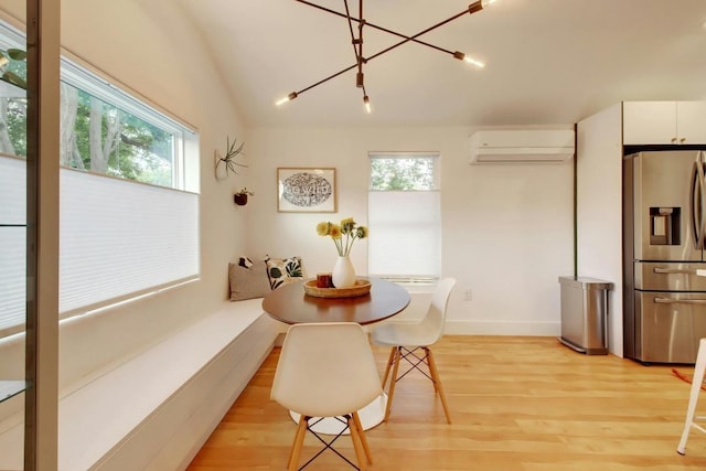 2000 E 8th St, Austin, TX 78702 - dining area with plenty of natural light, a wall unit AC, light wood finished floors, and baseboards