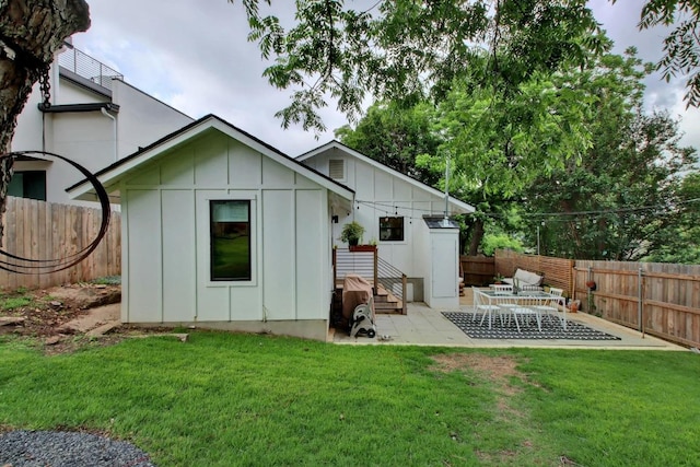 2000 E 8th St, Austin, TX 78702 - rear view of house with board and batten siding and a patio area