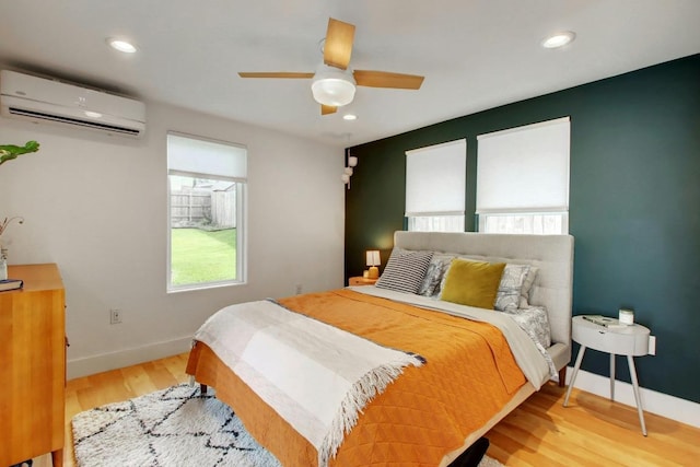 2000 E 8th St, Austin, TX 78702 - bedroom with an AC wall unit, light wood-style floors, baseboards, recessed lighting, and ceiling fan
