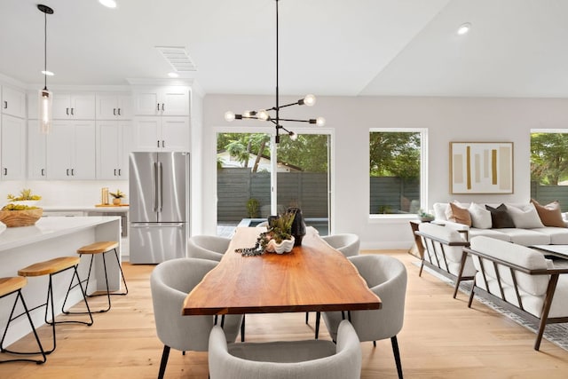 dining space with a chandelier, light wood finished floors, and recessed lighting