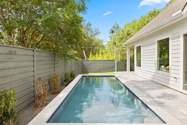view of pool with a fenced backyard and a patio
