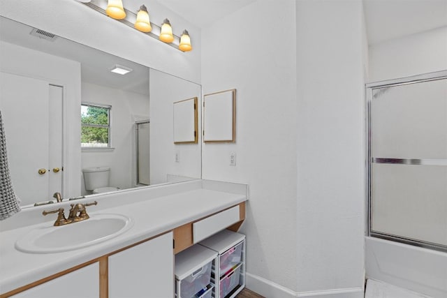 full bath with toilet, baseboards, vanity, and combined bath / shower with glass door