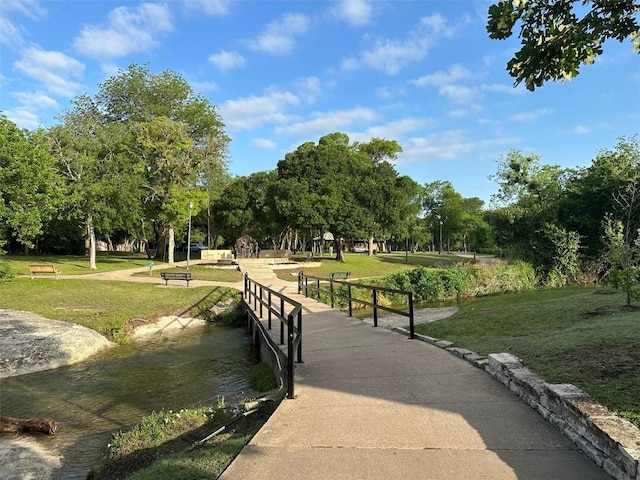 view of home's community featuring a lawn and view of wooded area