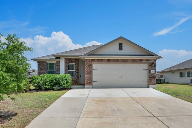 113 Evening Dusk Dr, Kyle, TX 78640 - view of front of house featuring brick siding, a garage, driveway, and a front yard