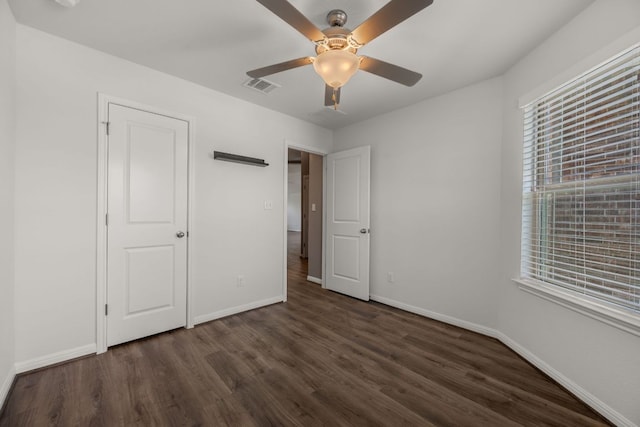 113 Evening Dusk Dr, Kyle, TX 78640 - unfurnished bedroom featuring dark wood finished floors and a ceiling fan