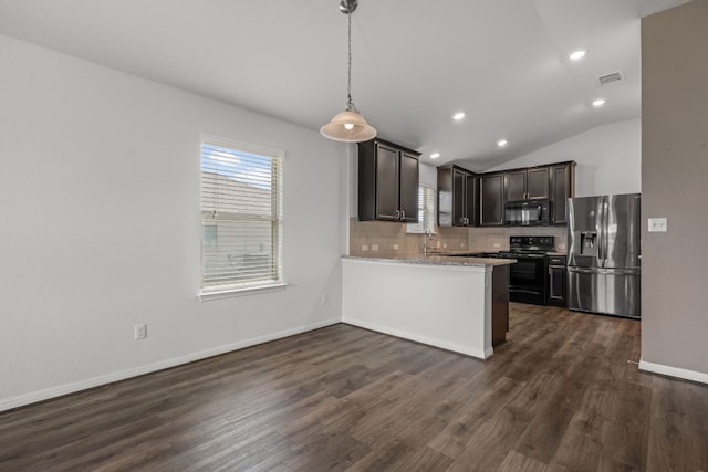 113 Evening Dusk Dr, Kyle, TX 78640 - kitchen with black appliances, dark brown cabinets, dark wood finished floors, decorative backsplash, and a peninsula