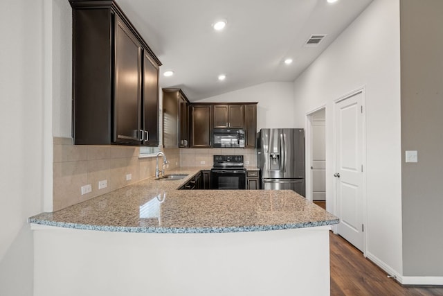 113 Evening Dusk Dr, Kyle, TX 78640 - kitchen with black appliances, dark brown cabinets, decorative backsplash, light stone counters, and dark wood finished floors