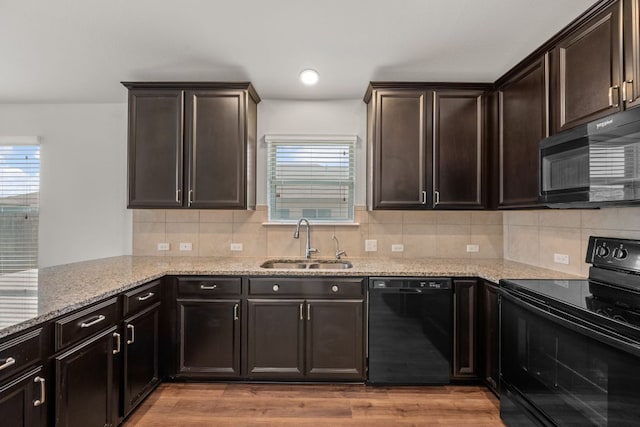 113 Evening Dusk Dr, Kyle, TX 78640 - kitchen featuring black appliances, light stone counters, healthy amount of natural light, backsplash, and recessed lighting