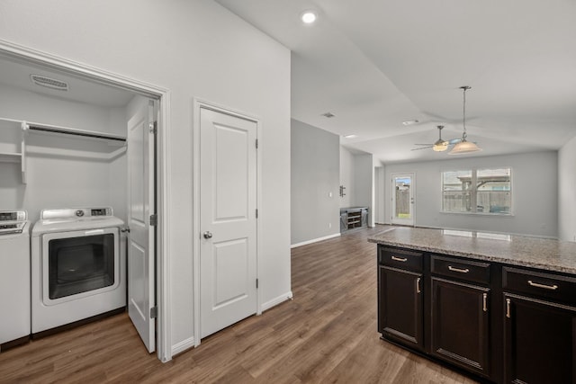 113 Evening Dusk Dr, Kyle, TX 78640 - kitchen featuring washing machine and clothes dryer, vaulted ceiling, ceiling fan, light wood finished floors, and light stone countertops