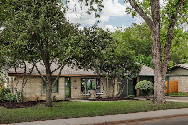 1805 Northridge Dr, Austin, TX 78723 - view of front of home featuring brick siding and roof with shingles