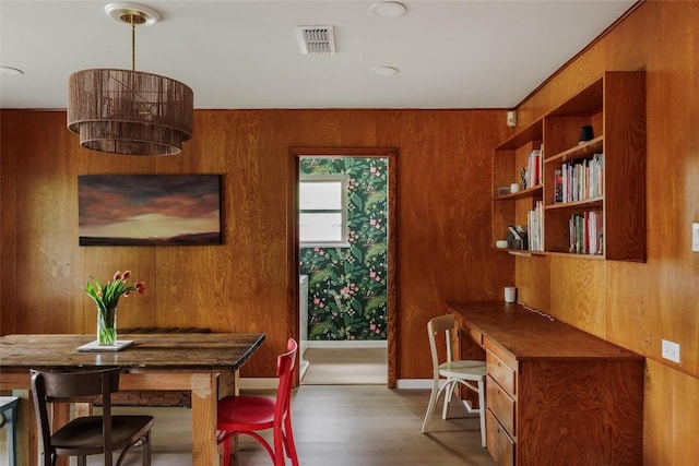 1805 Northridge Dr, Austin, TX 78723 - dining space featuring wood finished floors, wood walls, and a desk