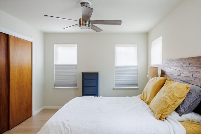 1805 Northridge Dr, Austin, TX 78723 - bedroom featuring light wood-type flooring, multiple windows, a closet, and baseboards