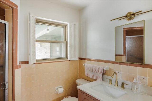 1805 Northridge Dr, Austin, TX 78723 - bathroom with a stall shower, toilet, vanity, tile walls, and wainscoting