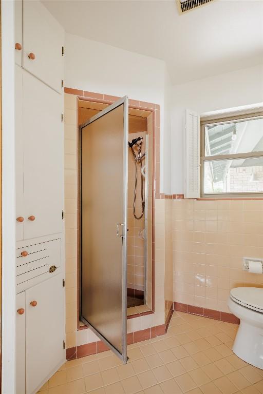 1805 Northridge Dr, Austin, TX 78723 - bathroom with a stall shower, tile patterned flooring, toilet, and tile walls