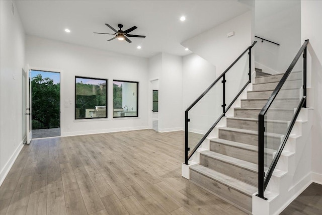 235 Canyon Turn Trl, Austin, TX 78734 - unfurnished living room featuring wood finished floors, stairway, ceiling fan, and recessed lighting