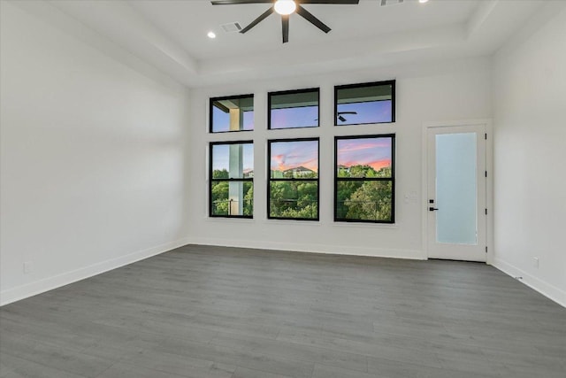 235 Canyon Turn Trl, Austin, TX 78734 - empty room with ceiling fan, dark wood-style floors, a tray ceiling, and recessed lighting