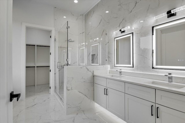 235 Canyon Turn Trl, Austin, TX 78734 - bathroom featuring marble tiled flooring, a marble finish shower, double vanity, a spacious closet, and recessed lighting
