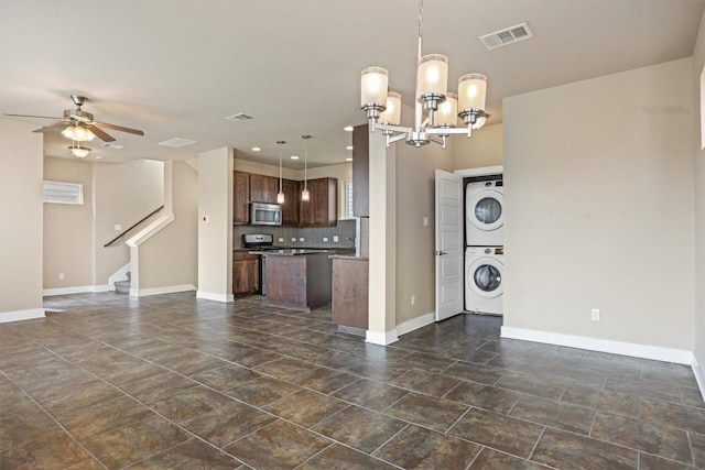 2621 Witsome Loop, Austin, TX 78741 - kitchen with stainless steel microwave, stacked washer / drying machine, open floor plan, ceiling fan, and recessed lighting