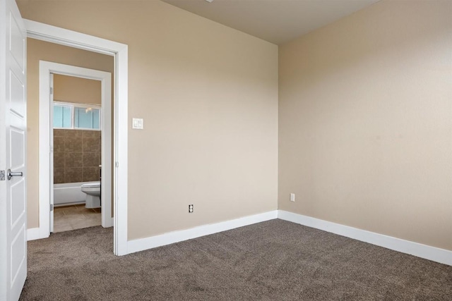 2621 Witsome Loop, Austin, TX 78741 - unfurnished room featuring dark colored carpet and baseboards