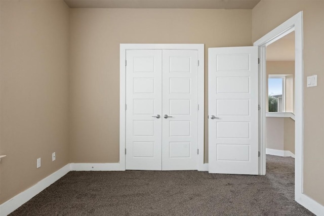 2621 Witsome Loop, Austin, TX 78741 - unfurnished bedroom with dark carpet, a closet, and baseboards