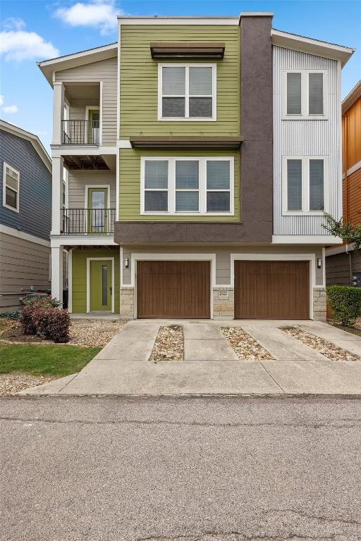 2621 Witsome Loop, Austin, TX 78741 - view of property with an attached garage and concrete driveway