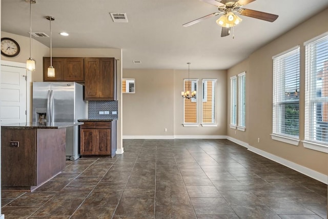 2621 Witsome Loop, Austin, TX 78741 - kitchen featuring stainless steel refrigerator with ice dispenser, a ceiling fan, a chandelier, and plenty of natural light