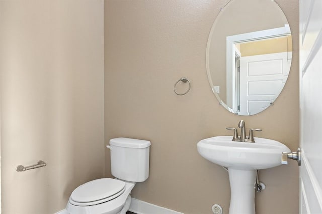 2621 Witsome Loop, Austin, TX 78741 - bathroom with toilet, baseboards, and a sink