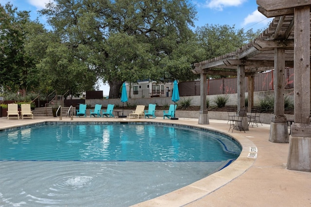 2621 Witsome Loop, Austin, TX 78741 - community pool with a pergola, fence, a patio, and stairway