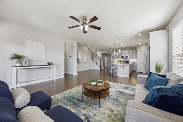 living area featuring dark wood-style flooring, ceiling fan, stairs, baseboards, and recessed lighting