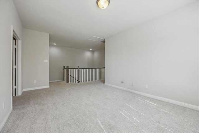 spare room featuring carpet flooring and baseboards
