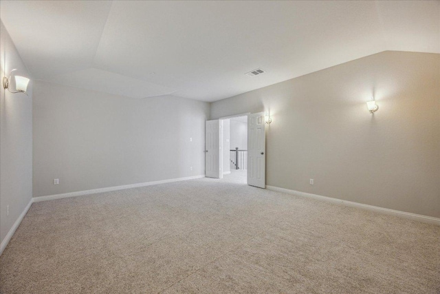 1716 Elaina Loop, Leander, TX 78641 - empty room with vaulted ceiling, light carpet, and baseboards