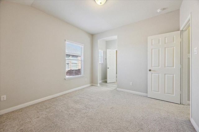 unfurnished bedroom with carpet flooring and baseboards