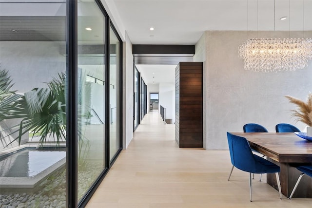 4202 Serene Hills Dr, Austin, TX 78738 - hall with a wall of windows, a chandelier, wood finished floors, and recessed lighting