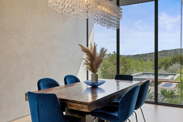4202 Serene Hills Dr, Austin, TX 78738 - dining space featuring floor to ceiling windows, plenty of natural light, and a chandelier