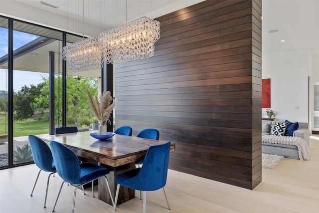 4202 Serene Hills Dr, Austin, TX 78738 - dining area featuring a chandelier, wood finished floors, wooden walls, and floor to ceiling windows