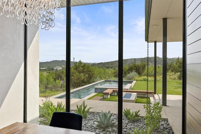 4202 Serene Hills Dr, Austin, TX 78738 - entryway featuring a wall of windows, a chandelier, and a mountain view