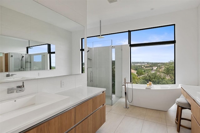 4202 Serene Hills Dr, Austin, TX 78738 - bathroom with a shower stall, double vanity, a freestanding tub, and tile patterned flooring