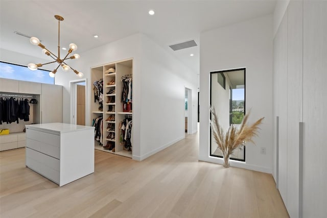 4202 Serene Hills Dr, Austin, TX 78738 - corridor with a chandelier, light wood finished floors, and baseboards