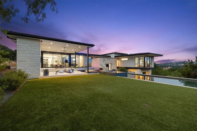 4202 Serene Hills Dr, Austin, TX 78738 - rear view of house featuring a patio, an outdoor pool, and a lawn