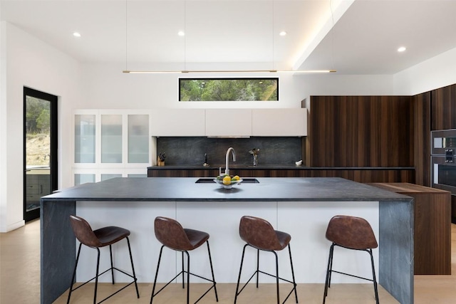 4202 Serene Hills Dr, Austin, TX 78738 - kitchen with modern cabinets, a sink, dark countertops, white cabinetry, and recessed lighting