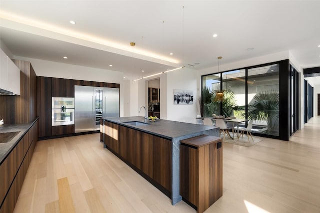 4202 Serene Hills Dr, Austin, TX 78738 - kitchen featuring modern cabinets, a sink, dark countertops, and recessed lighting