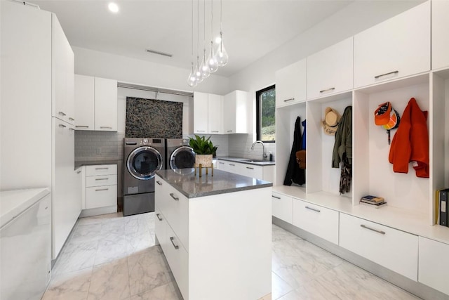 4202 Serene Hills Dr, Austin, TX 78738 - kitchen featuring washer and dryer, light marble finish flooring, a sink, fridge, and a kitchen island
