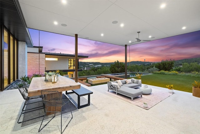 4202 Serene Hills Dr, Austin, TX 78738 - patio terrace at dusk featuring a patio area, an outdoor living space, outdoor dining space, and a lawn