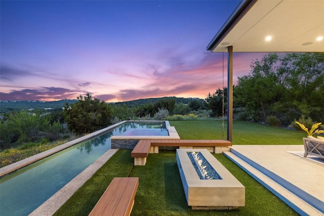 4202 Serene Hills Dr, Austin, TX 78738 - view of swimming pool with a fire pit, an infinity pool, a yard, and a patio area
