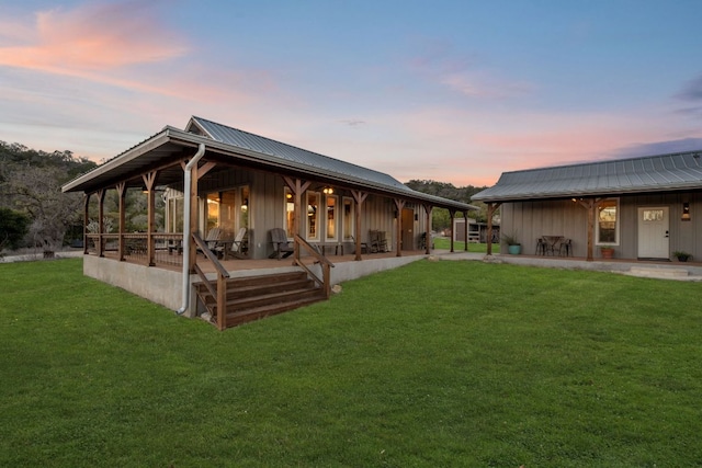 105 Valley View Trl, Comfort, TX 78013 - rear view of property with board and batten siding, a lawn, metal roof, and a patio