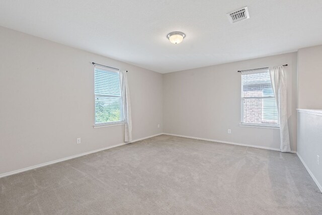 carpeted spare room with baseboards
