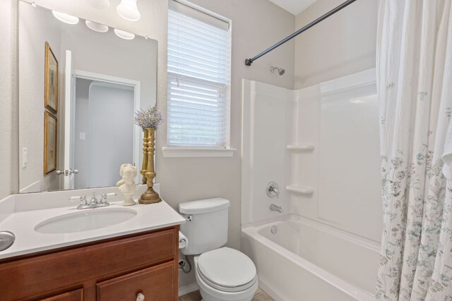 full bathroom featuring toilet, shower / bath combination with curtain, and vanity