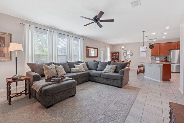 living room with ceiling fan, light tile patterned flooring, baseboards, and recessed lighting